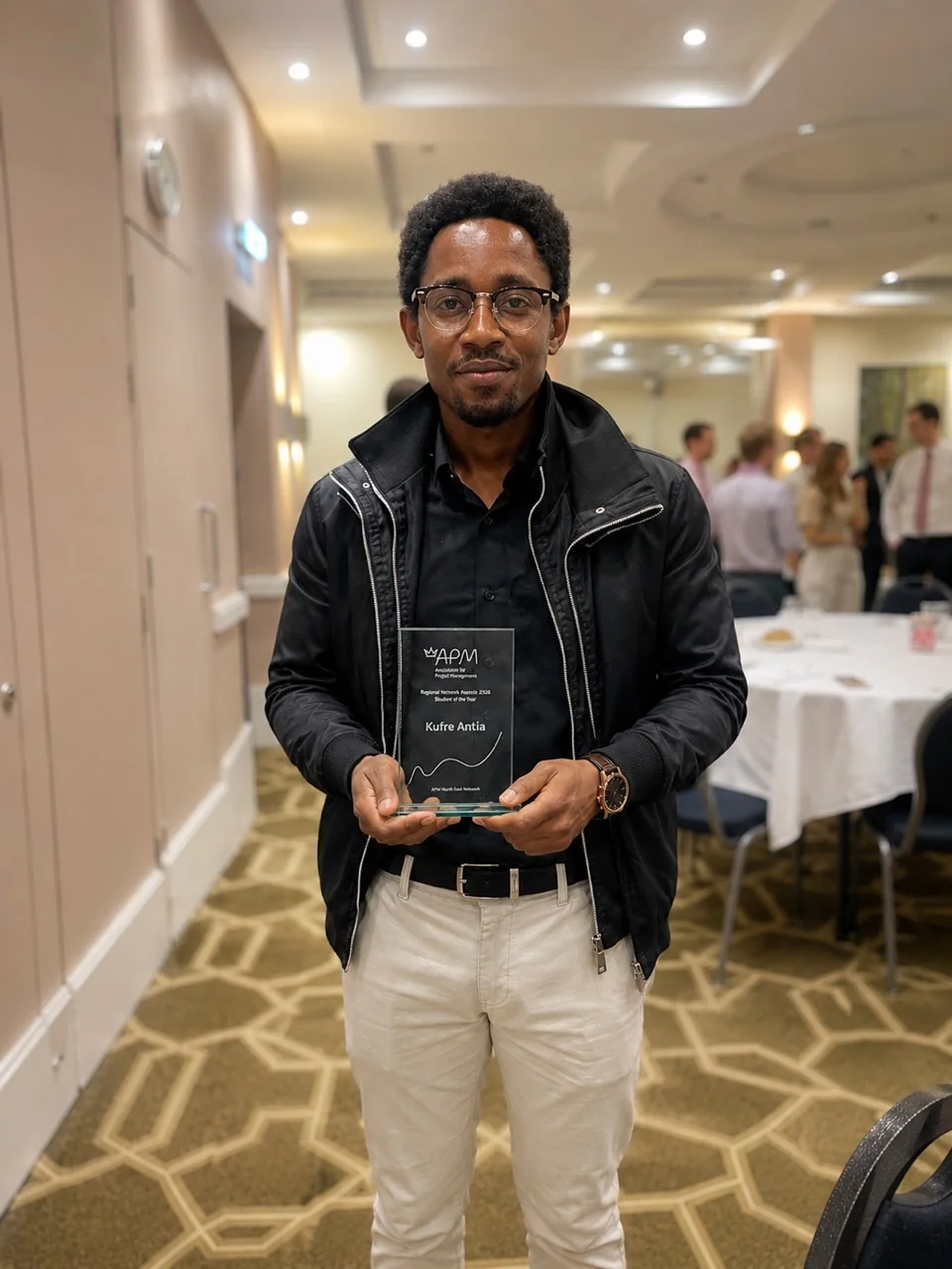 Kufre Antia holding the Association for Project Management Student of the Year award